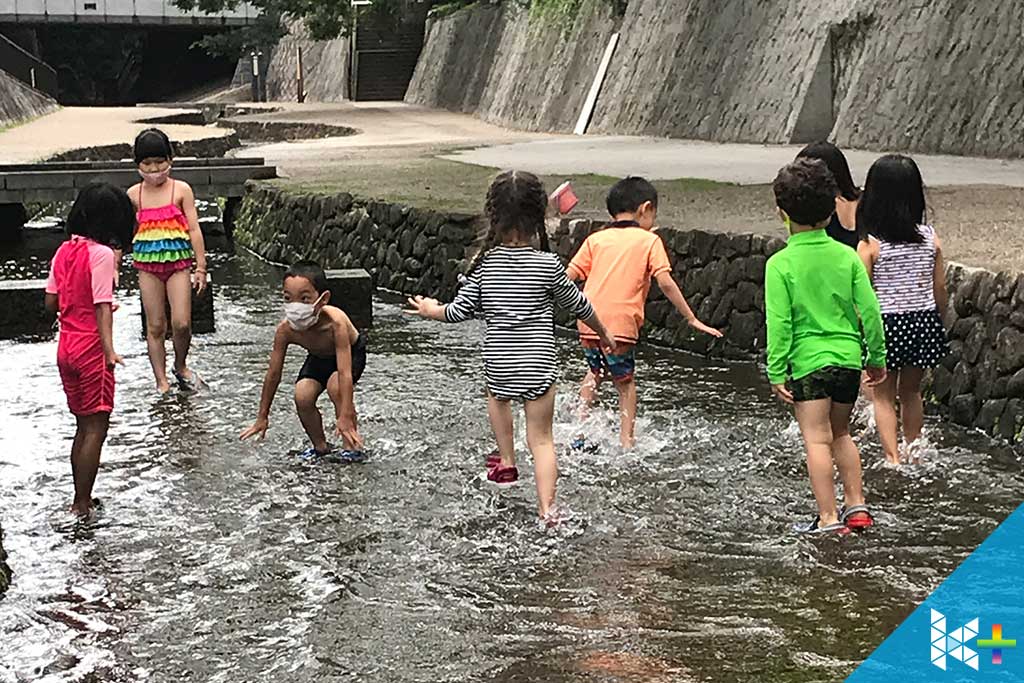 Image of students having a fun time in the local river during a hot summer in Kyoto