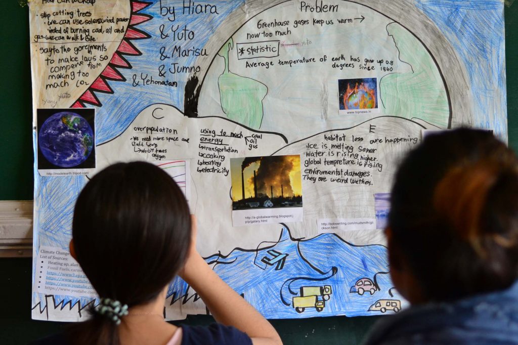 Image of students looking at PYP passion project poster